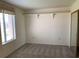 Simple bedroom with carpet, window, and mirrored closet at 17404 N 99Th Ave # 317, Sun City, AZ 85373