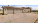 Two-car garage with light tan exterior and a concrete driveway at 16907 E Gloria Ln, Rio Verde, AZ 85263