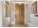 Elegant entryway with a rustic wood door, tile flooring, and a bench at 16907 E Gloria Ln, Rio Verde, AZ 85263