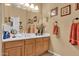 Bathroom with wood cabinets and a large vanity mirror at 1413 W Commerce Ave, Gilbert, AZ 85233