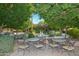 Relaxing patio area with tables, chairs, and lush greenery at 17041 W Artesia Dr, Surprise, AZ 85387