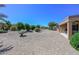 Spacious backyard with gravel and mature plants at 17041 W Artesia Dr, Surprise, AZ 85387
