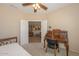 Bright bedroom with built-in desk and access to the living area at 17041 W Artesia Dr, Surprise, AZ 85387