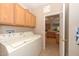 Laundry room with washer, dryer, and cabinets at 17041 W Artesia Dr, Surprise, AZ 85387