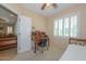 Well-lit bedroom featuring a desk and backyard view at 17041 W Artesia Dr, Surprise, AZ 85387