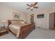 Spacious primary bedroom with a large sleigh bed and ample natural light at 17041 W Artesia Dr, Surprise, AZ 85387
