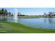 Scenic lake view with fountain and golf course in background at 17041 W Artesia Dr, Surprise, AZ 85387