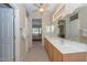 Double vanity bathroom with view into bedroom and good lighting at 17041 W Artesia Dr, Surprise, AZ 85387