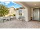 Covered patio with seating area and decorative front door at 26803 W Firehawk Dr, Buckeye, AZ 85396