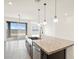 Modern kitchen island with granite countertops and a large sink at 37232 W Patterson St, Maricopa, AZ 85138