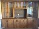 Built-in wooden cabinets with glass doors and ample storage space at 10035 W Riviera Dr, Sun City, AZ 85351