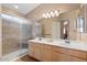 Bathroom with double vanity, large mirror, and walk-in shower at 18809 N 39Th Way, Phoenix, AZ 85050