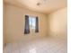 Simple bedroom with tiled floor, window, and closet at 19717 E Chestnut Dr, Queen Creek, AZ 85142