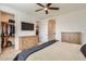 Bedroom with a large bed, dresser, walk-in closet, and ensuite bathroom at 3103 E Hayfield Way, San Tan Valley, AZ 85140