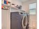 Functional laundry room with washer, dryer, and storage shelves at 3103 E Hayfield Way, San Tan Valley, AZ 85140