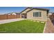 Artificial turf backyard with a paved patio and seating area at 3103 E Hayfield Way, San Tan Valley, AZ 85140