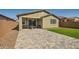 Artificial turf backyard with a paved patio and seating area at 3103 E Hayfield Way, San Tan Valley, AZ 85140