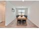 Bright dining room features a spacious wooden table with black chairs at 3103 E Hayfield Way, San Tan Valley, AZ 85140