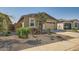 Modern house with a two-car garage and desert landscaping at 3103 E Hayfield Way, San Tan Valley, AZ 85140