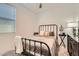 Bedroom with a metal bed frame and window coverings at 3103 E Hayfield Way, San Tan Valley, AZ 85140