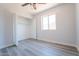 Bright bedroom with new flooring and a spacious closet at 3833 W Woodridge Dr, Glendale, AZ 85308