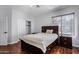 Bright bedroom with wood flooring, double closet, and window coverings at 192 W Los Arboles Dr, Tempe, AZ 85284