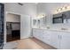 Double vanity bathroom with white cabinets and quartz countertops at 192 W Los Arboles Dr, Tempe, AZ 85284