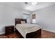 Comfortable bedroom with wood floors and a ceiling fan at 192 W Los Arboles Dr, Tempe, AZ 85284