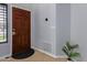 Interior entry with wood door and tile floor at 192 W Los Arboles Dr, Tempe, AZ 85284