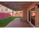 Covered patio with brick flooring and artificial turf at 192 W Los Arboles Dr, Tempe, AZ 85284