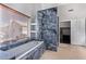 Luxurious bathroom with a soaking tub and marble-look tile at 192 W Los Arboles Dr, Tempe, AZ 85284