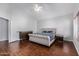 Well-lit bedroom with wood flooring and a ceiling fan at 192 W Los Arboles Dr, Tempe, AZ 85284