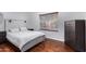 Cozy bedroom with wood flooring and a large dresser at 192 W Los Arboles Dr, Tempe, AZ 85284