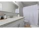 Clean bathroom with white vanity and a large mirror at 192 W Los Arboles Dr, Tempe, AZ 85284