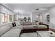 Spacious living room with a large sectional sofa and view into the kitchen at 192 W Los Arboles Dr, Tempe, AZ 85284