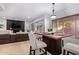 Kitchen dining area with a modern wood table and seating for four at 192 W Los Arboles Dr, Tempe, AZ 85284