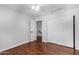 Light and airy bedroom with wood floors and access to upper level at 192 W Los Arboles Dr, Tempe, AZ 85284