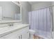 Clean bathroom with white vanity, shower, and gray shower curtain at 192 W Los Arboles Dr, Tempe, AZ 85284
