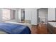Spacious bedroom with wood floors and access to a bathroom at 192 W Los Arboles Dr, Tempe, AZ 85284