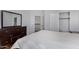 Spacious bedroom with wood floors, large closet, and view of upper level at 192 W Los Arboles Dr, Tempe, AZ 85284