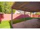 Covered patio with brick flooring and artificial turf at 192 W Los Arboles Dr, Tempe, AZ 85284