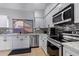 Modern kitchen with stainless steel appliances and granite countertops at 192 W Los Arboles Dr, Tempe, AZ 85284