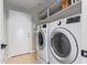 Laundry room with washer, dryer, and overhead shelving at 192 W Los Arboles Dr, Tempe, AZ 85284
