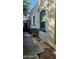 View of the side of a house with stucco walls, blue-framed windows and a walkway at 2322 N 8Th St, Phoenix, AZ 85006