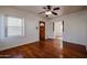 Living room with hardwood floors, a built-in shelf, and front door access at 2322 N 8Th St, Phoenix, AZ 85006
