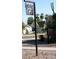 Metal neighborhood entrance sign with house design, desert landscaping, and palm trees in background at 2322 N 8Th St, Phoenix, AZ 85006