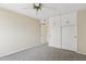 Bedroom with ceiling fan, carpet, and large closet at 10004 W Desert Forest Cir, Sun City, AZ 85351