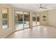 Bright Gathering room with tile floors and sliding glass doors leading to a view of the pool at 10004 W Desert Forest Cir, Sun City, AZ 85351