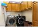 Laundry room with washer, dryer, and upper cabinets at 44811 N 12Th St, New River, AZ 85087