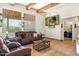 Spacious living room with wood beams, tiled floors, and comfortable seating at 44811 N 12Th St, New River, AZ 85087
